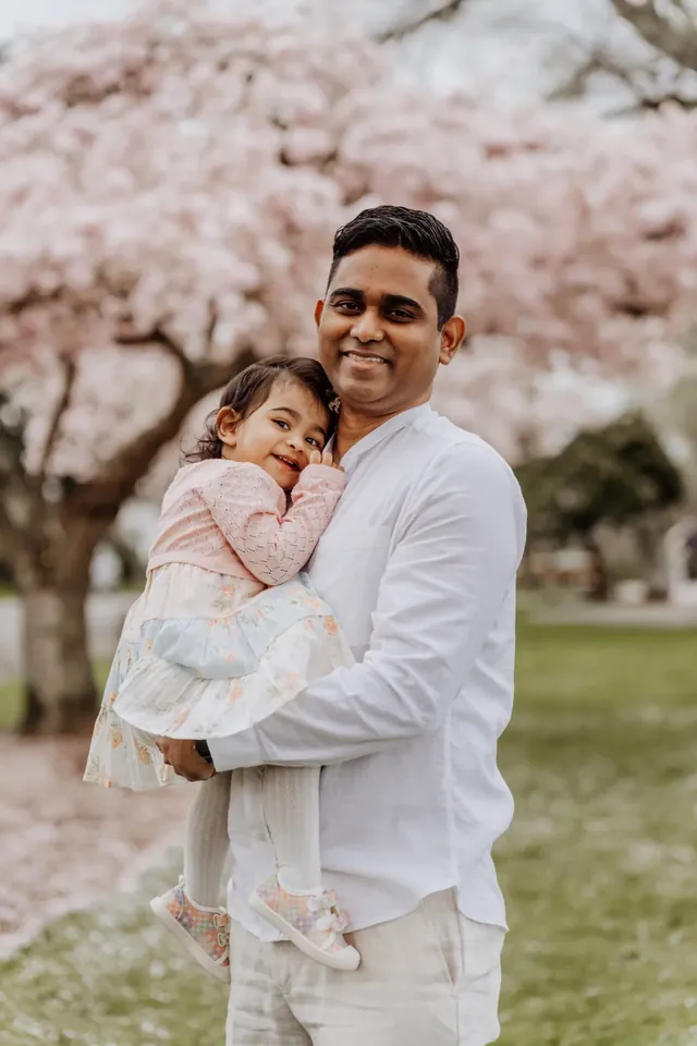 Father and daughter under cherry blossoms in Snohomish County WA