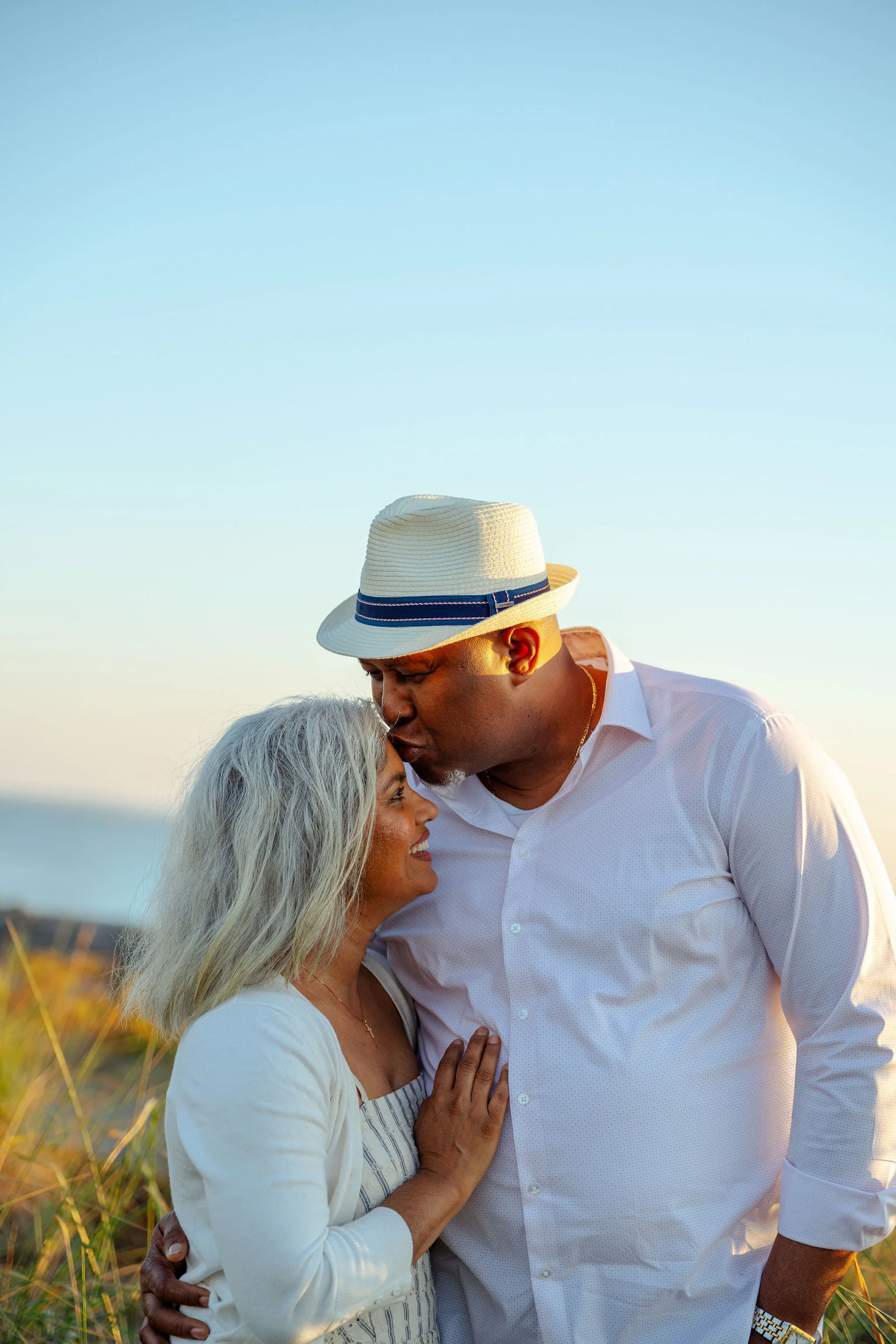 A couple sharing a quiet moment on the beach at sunset
