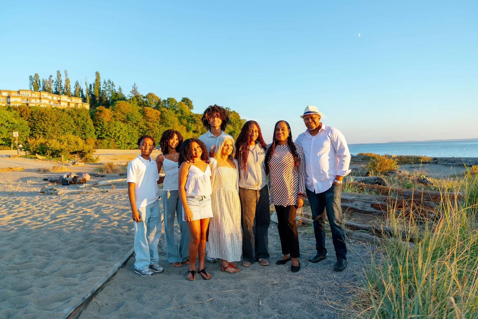 Family lined up on the beach as the sun drops