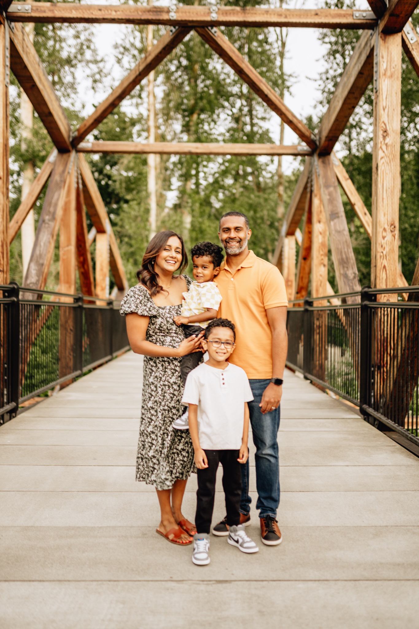 Family of four on bridge in summer golden hour