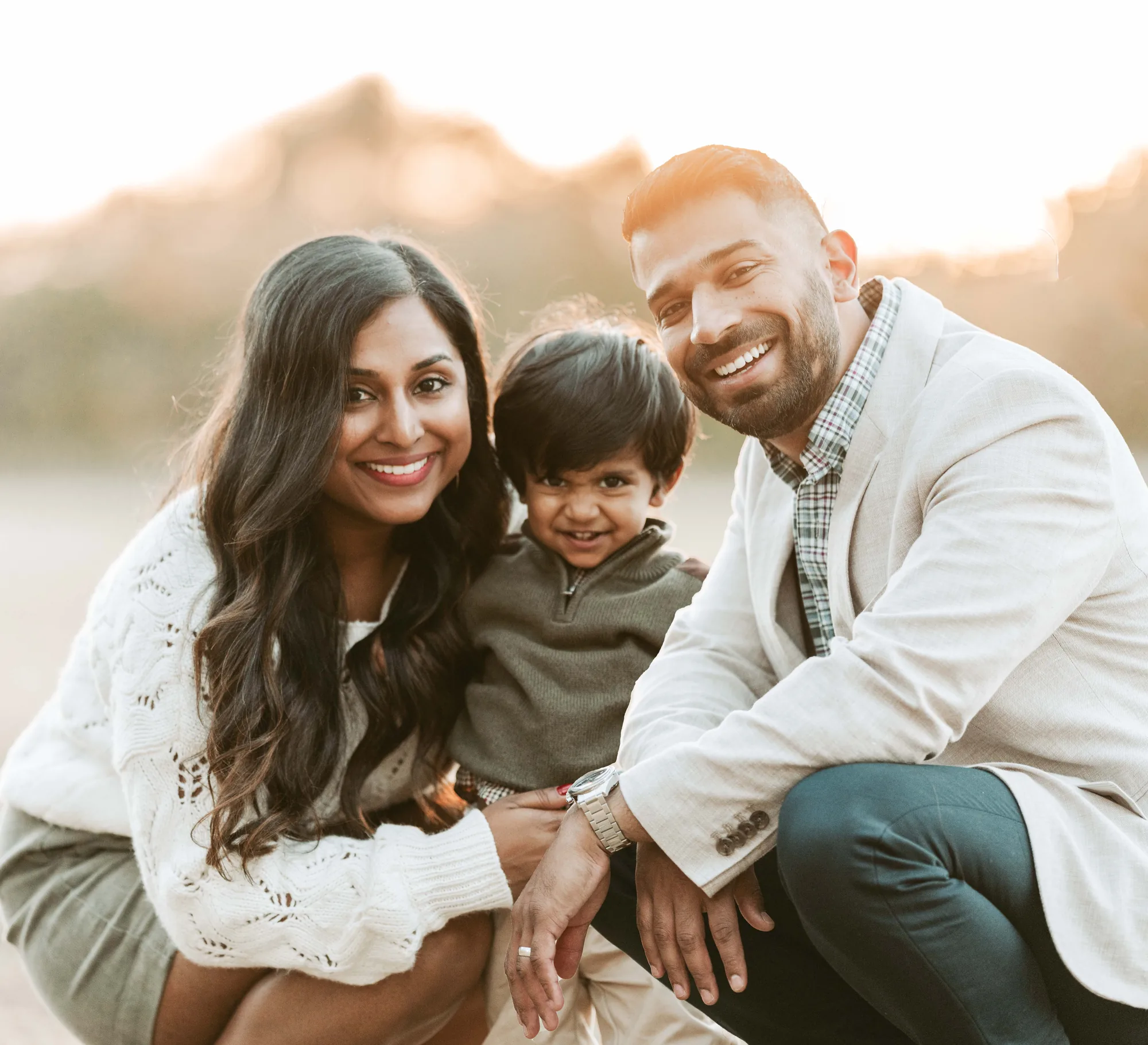 Family with their toddler at golden hour