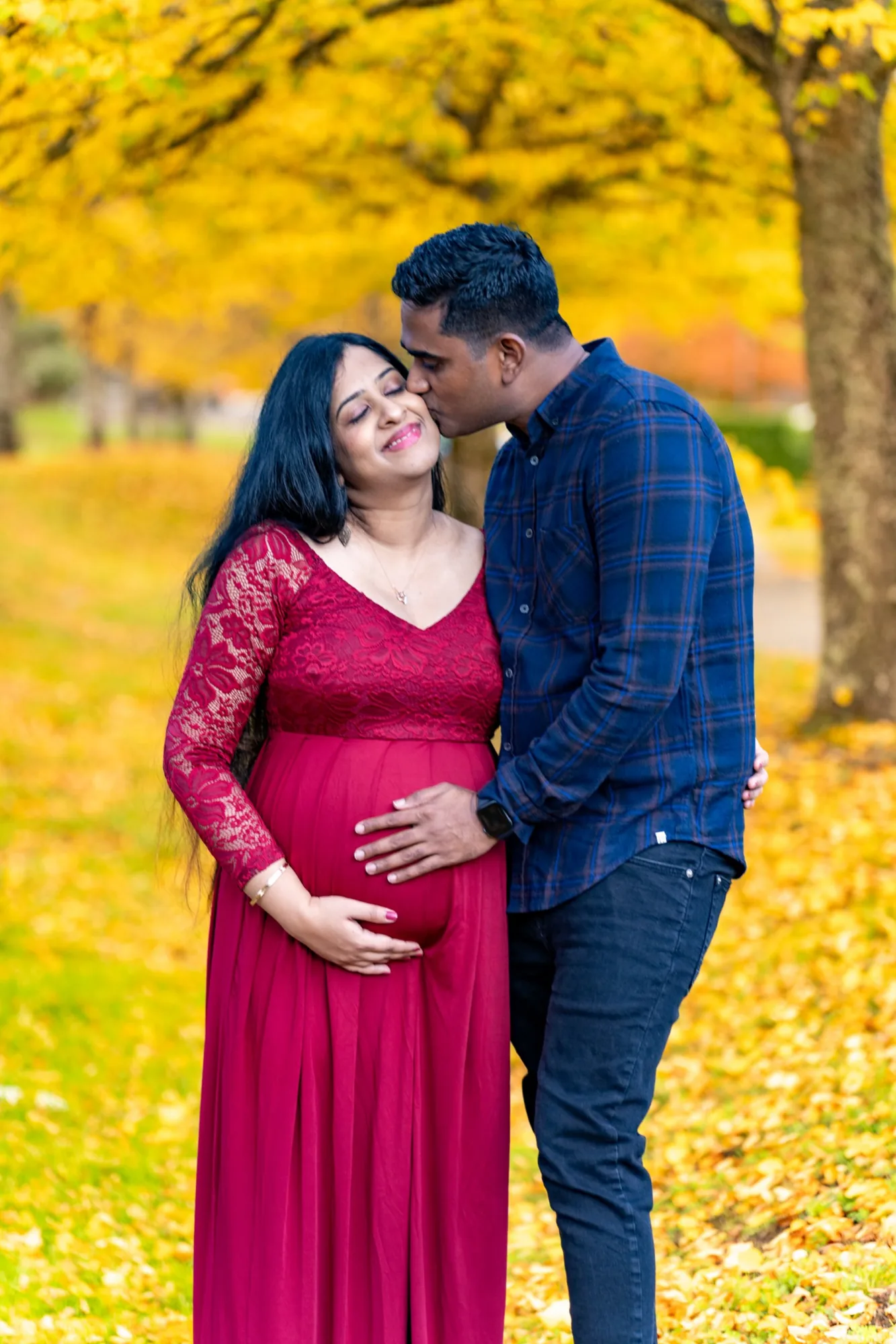 Bothell maternity couple in autumn with red dress
