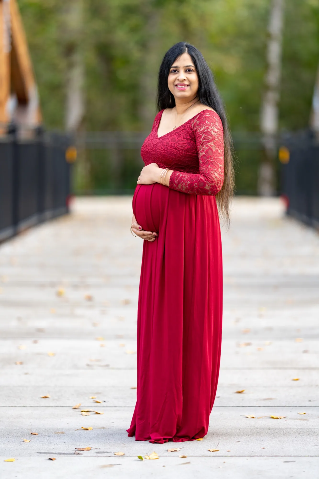 Maternity portrait on wooden bridge walkway in Bothell