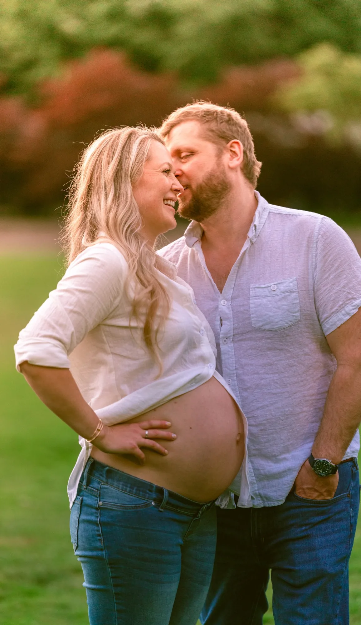 Parents-to-be nose to nose at their sunset maternity session