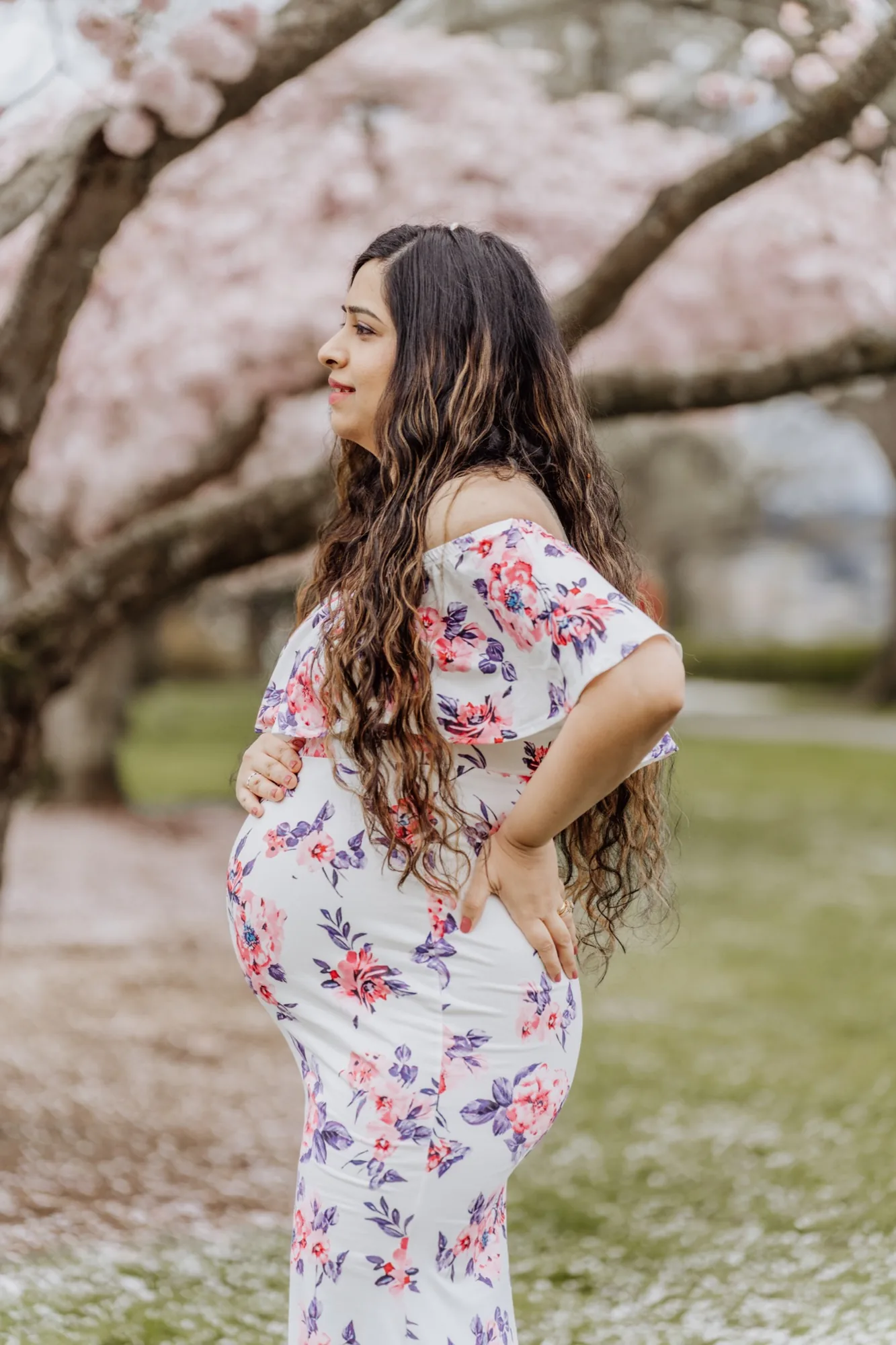 Expecting mother side profile under cherry blossoms in Snohomish County maternity session