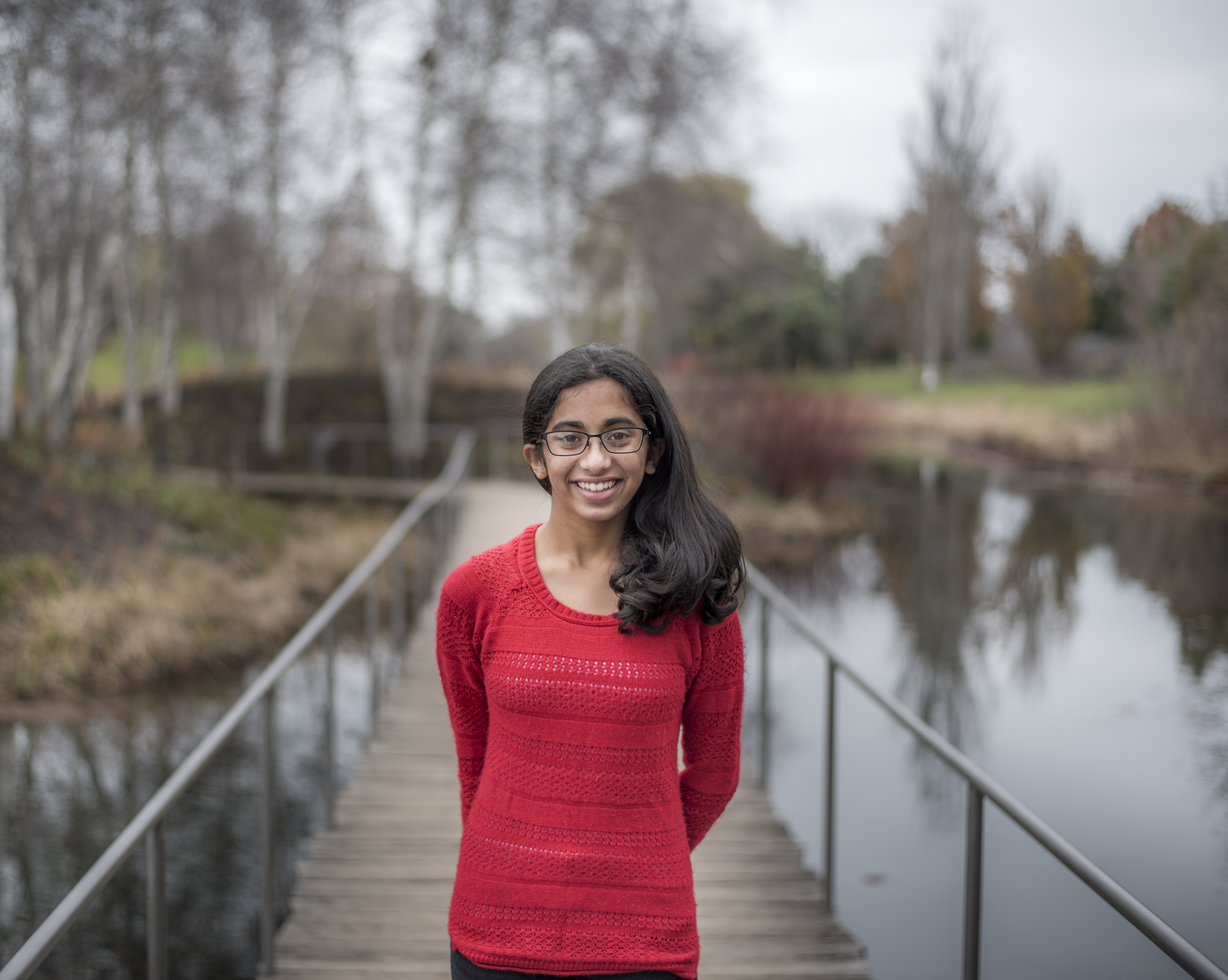 Snohomish County senior portrait on wooden bridge over pond at North Cove