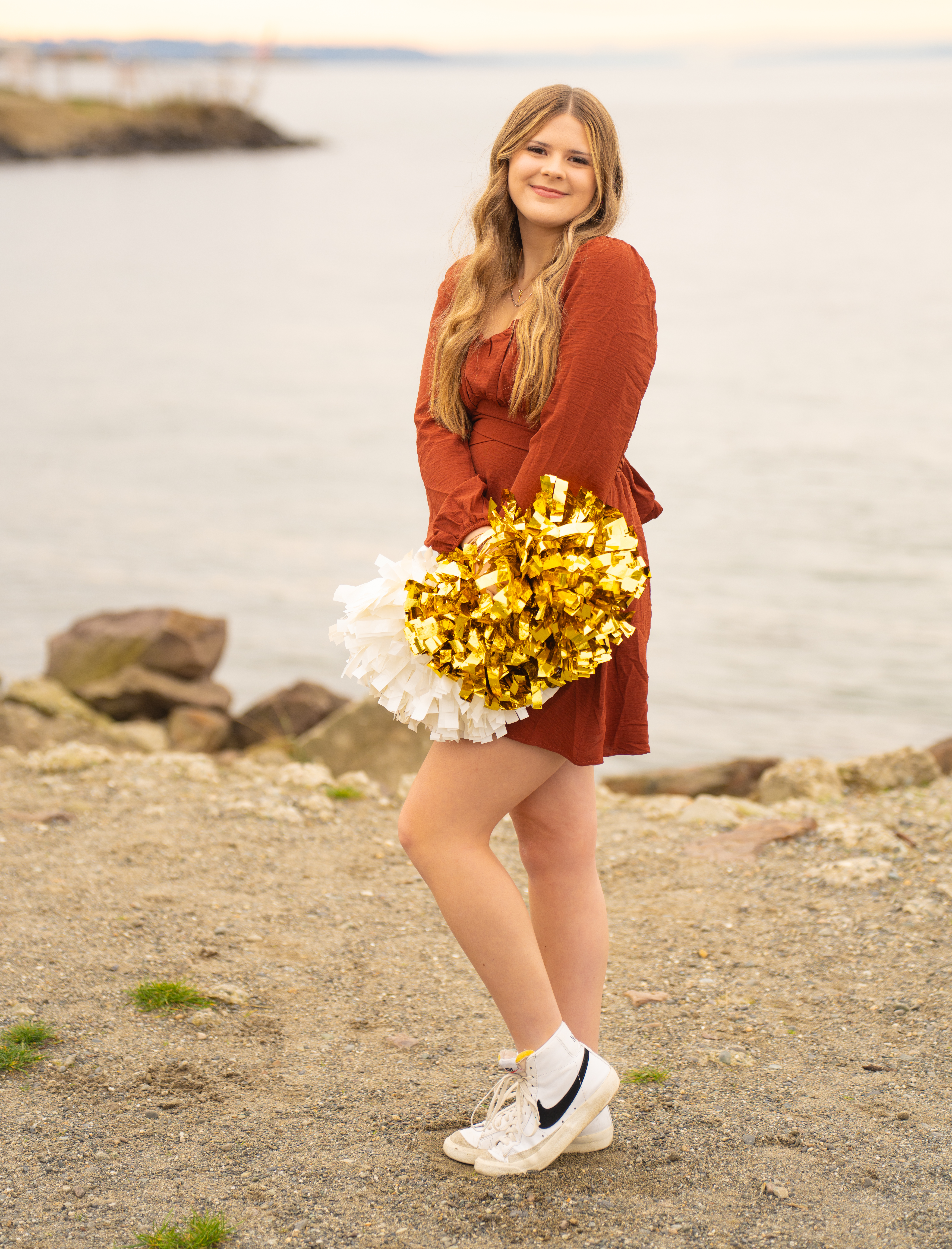 Lake Stevens High School senior cheerleader with pom poms on beach