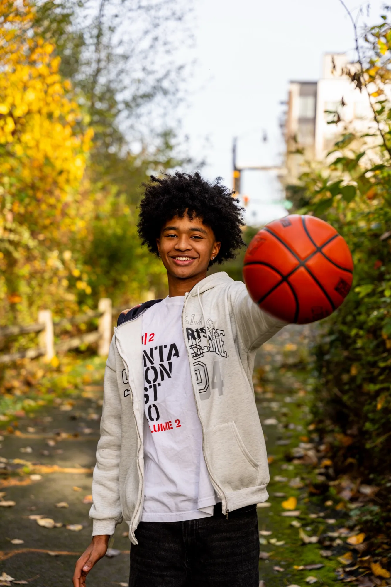 Senior athlete with basketball during autumn portrait session in Snohomish County