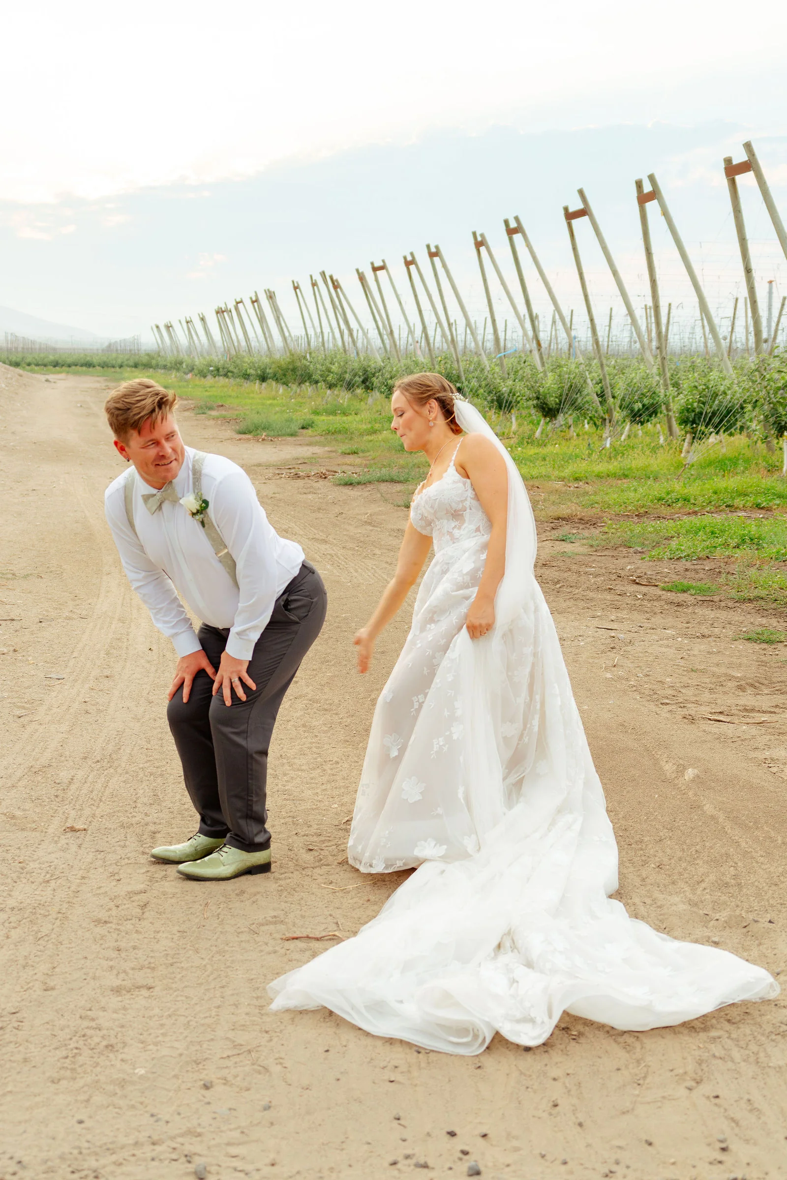 A playful moment on the orchard road after the ceremony