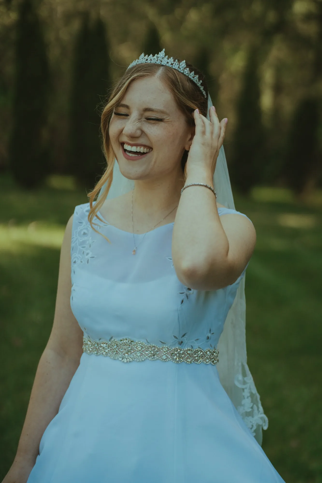 Bride laughing joyfully with tiara and veil at Snohomish County wedding