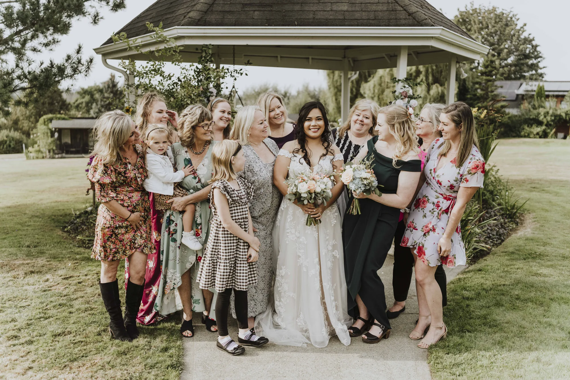 Bride with bridesmaids at gazebo near Bothell wedding venue