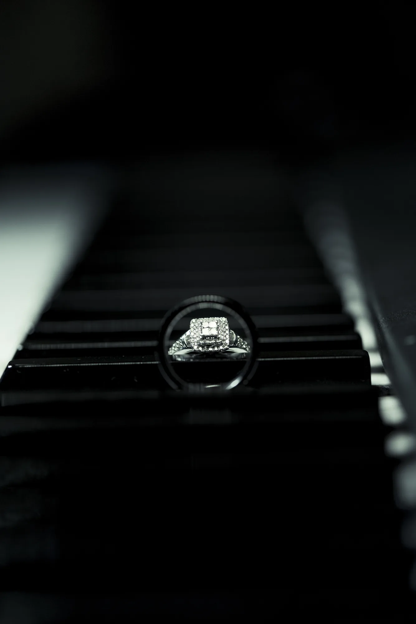 Wedding ring on piano keys with reflection in Snohomish County