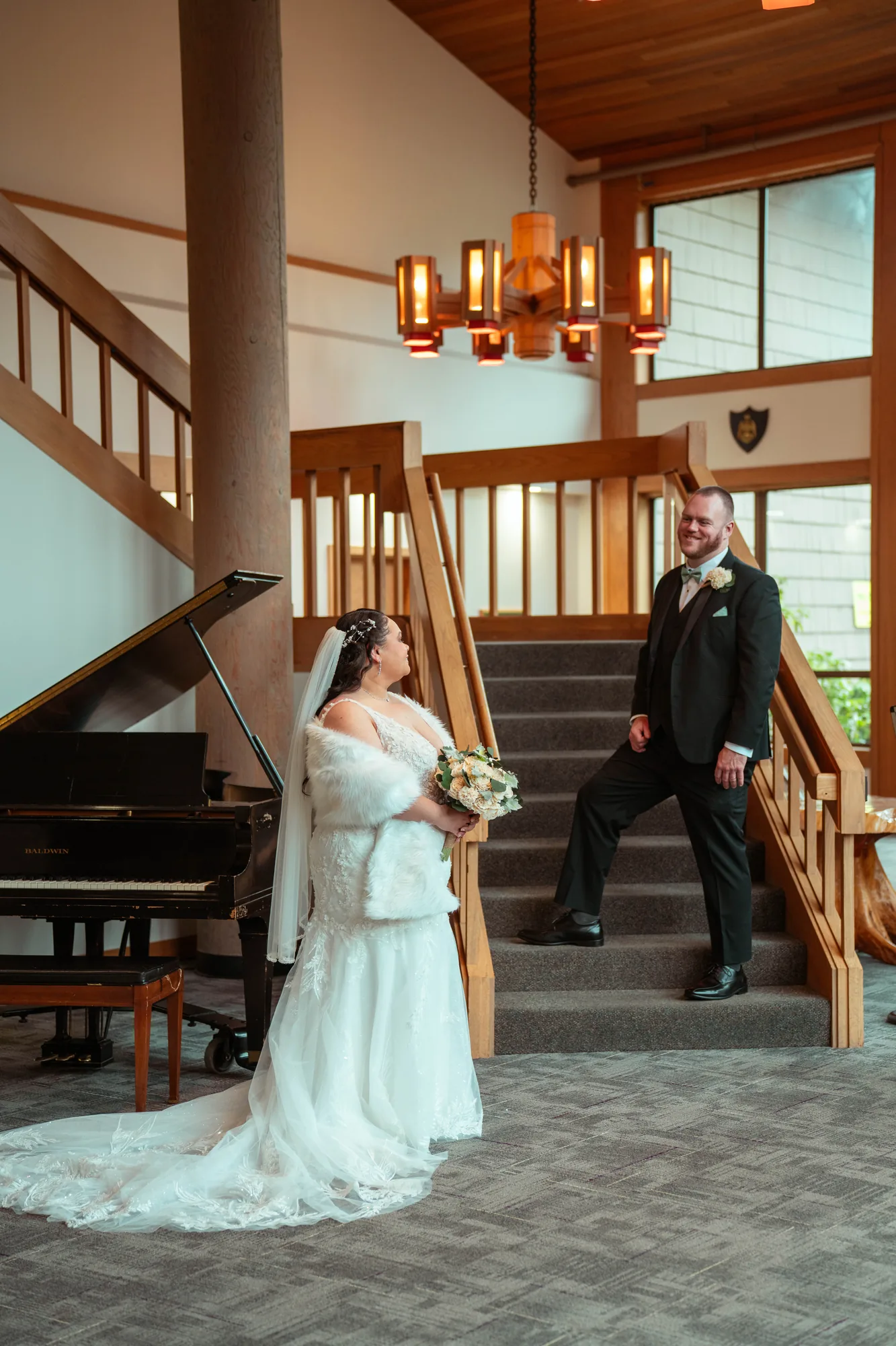 Bride and groom portrait on wooden staircase with piano at Snohomish County wedding venue