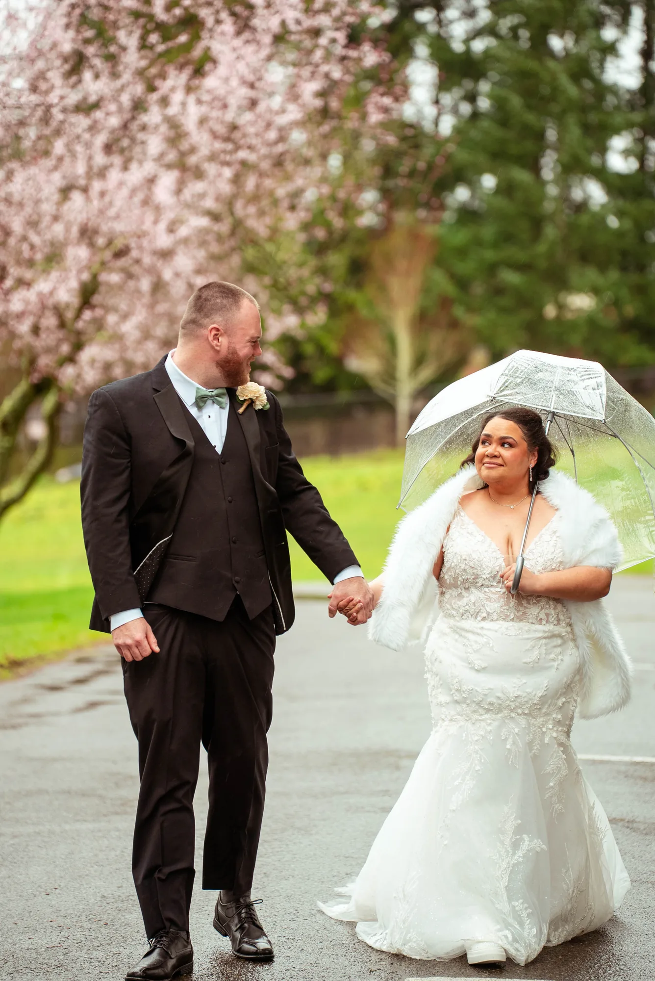 Wedding couple walking in rain with umbrella at Snohomish County