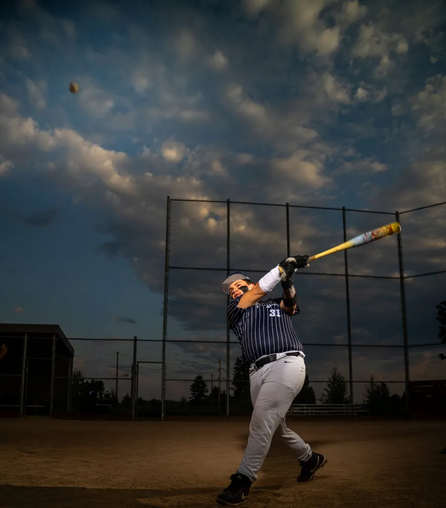 Senior baseball player at bat under stadium lights — SunnyT Productions