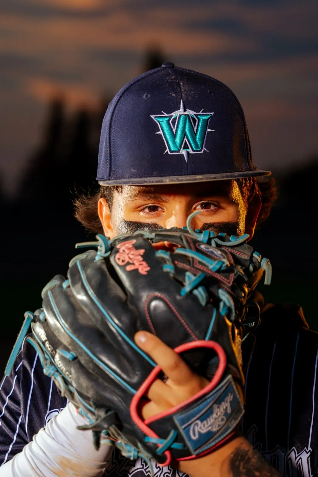 Senior athlete portrait on the field at golden hour