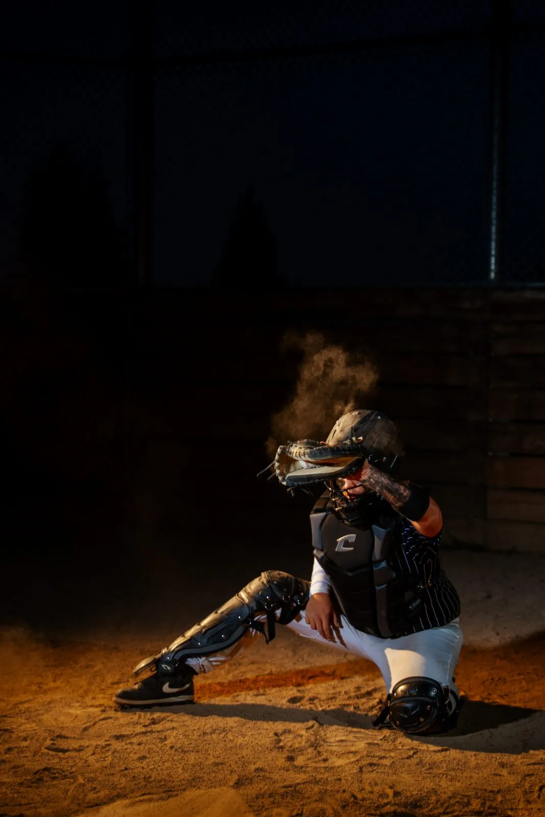 Senior athlete portrait with gear, low-key lighting
