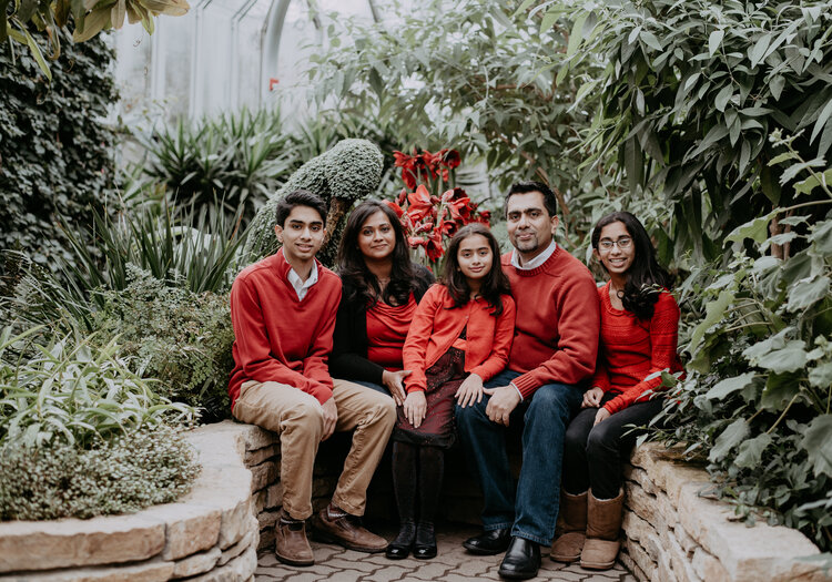 a family of five members wearing red color dresses